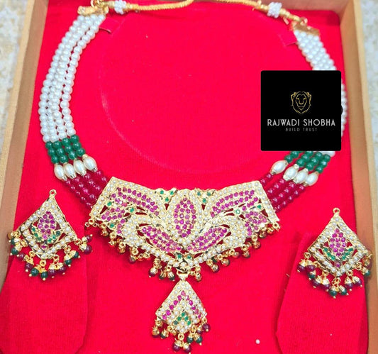 A stunning Manak moti jadau necklace featuring pink and green stones, elegantly designed for a luxurious look.