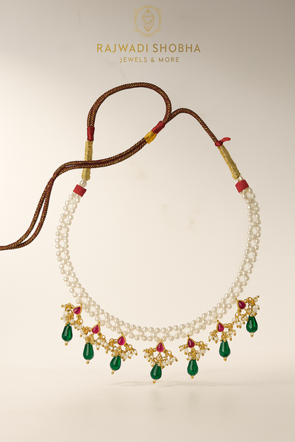 Necklace featuring green and white pearls interspersed with red beads, designed as artificial jewelry