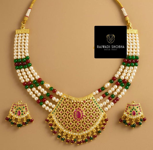 A gold and red Manak moti jadau necklace and earrings set
