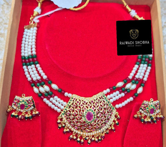A gold and red Manak moti jadau necklace and earrings set