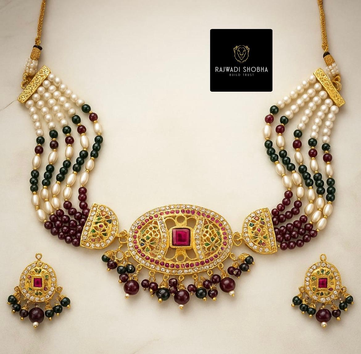 Jadau necklace featuring pearls and green stones, showcasing intricate craftsmanship and elegant design.